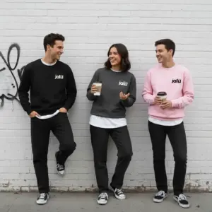 Two men and one woman wearing Jalil unisex solid hoodies outdoors